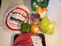 This is a picture of the ingredients that will be used for the recipe to make authentic Mexican Burritos including meat, cheese, beans, onion, lettuce, green pepper, and special burrito tortillas.
